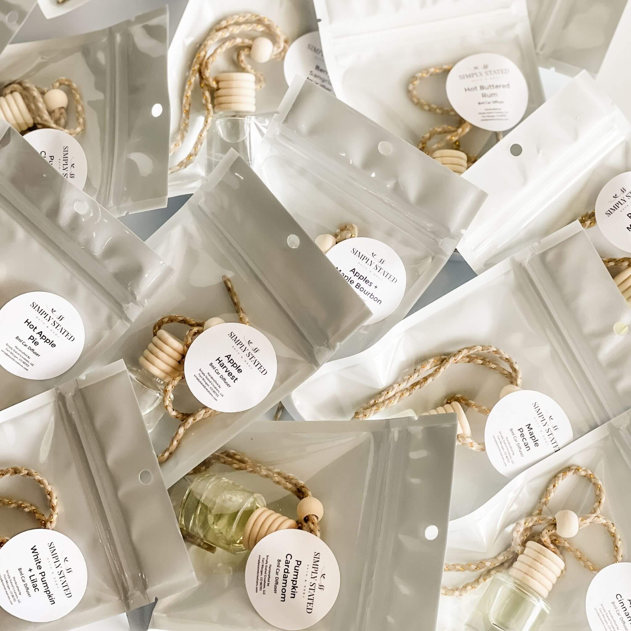 Simply Stated Fall Car Diffusers in assorted seasonal scents packaged with wood tops and hanging cords