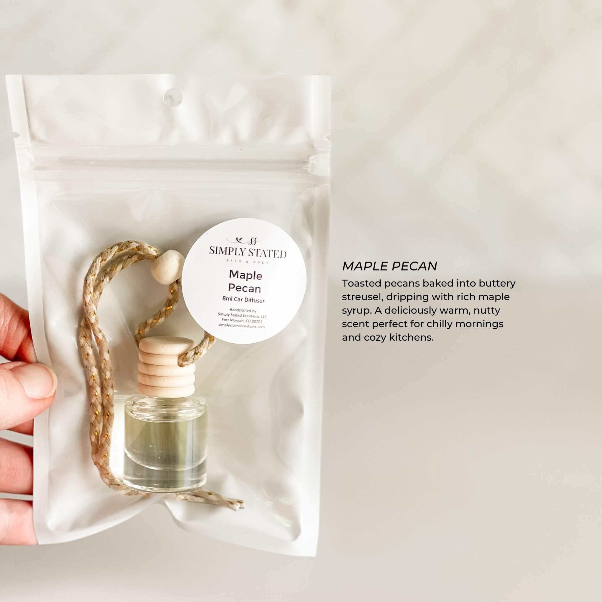 Small bottle of perfume with a label on a white background