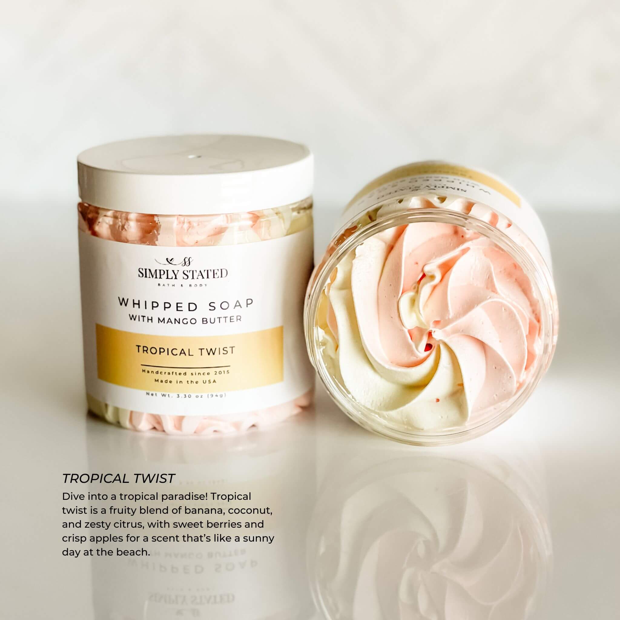 Simply Stated Bath & Body Tropical Twist Whipped Soap for kids. A bright swirl of pink and yellow with a fruity blend of banana, coconut, and zesty citrus for a tropical bath time escape. Made with mango butter for gentle cleansing.