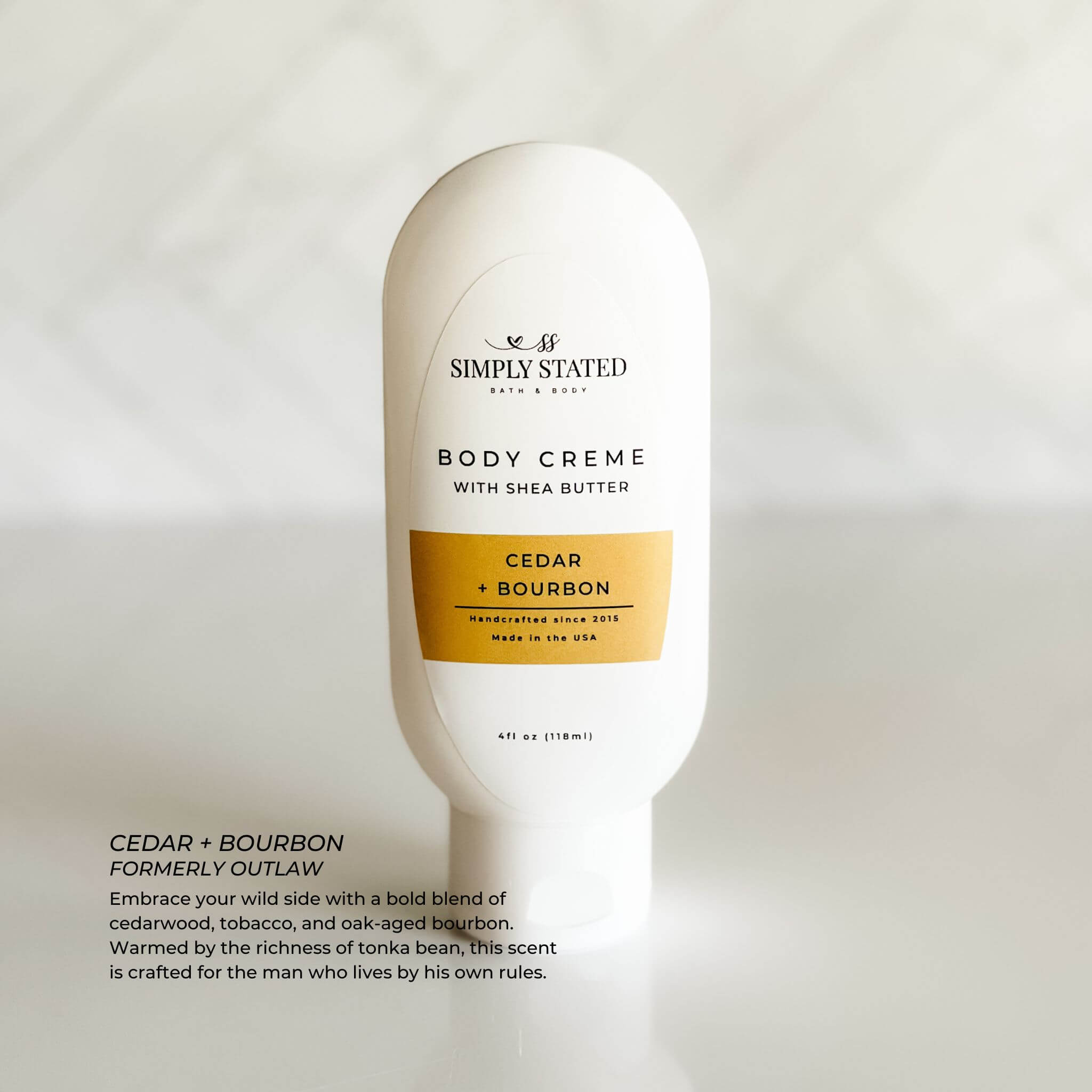 Cedar + Bourbon 4 oz bottle with white minimalist packaging, perfect for travel.