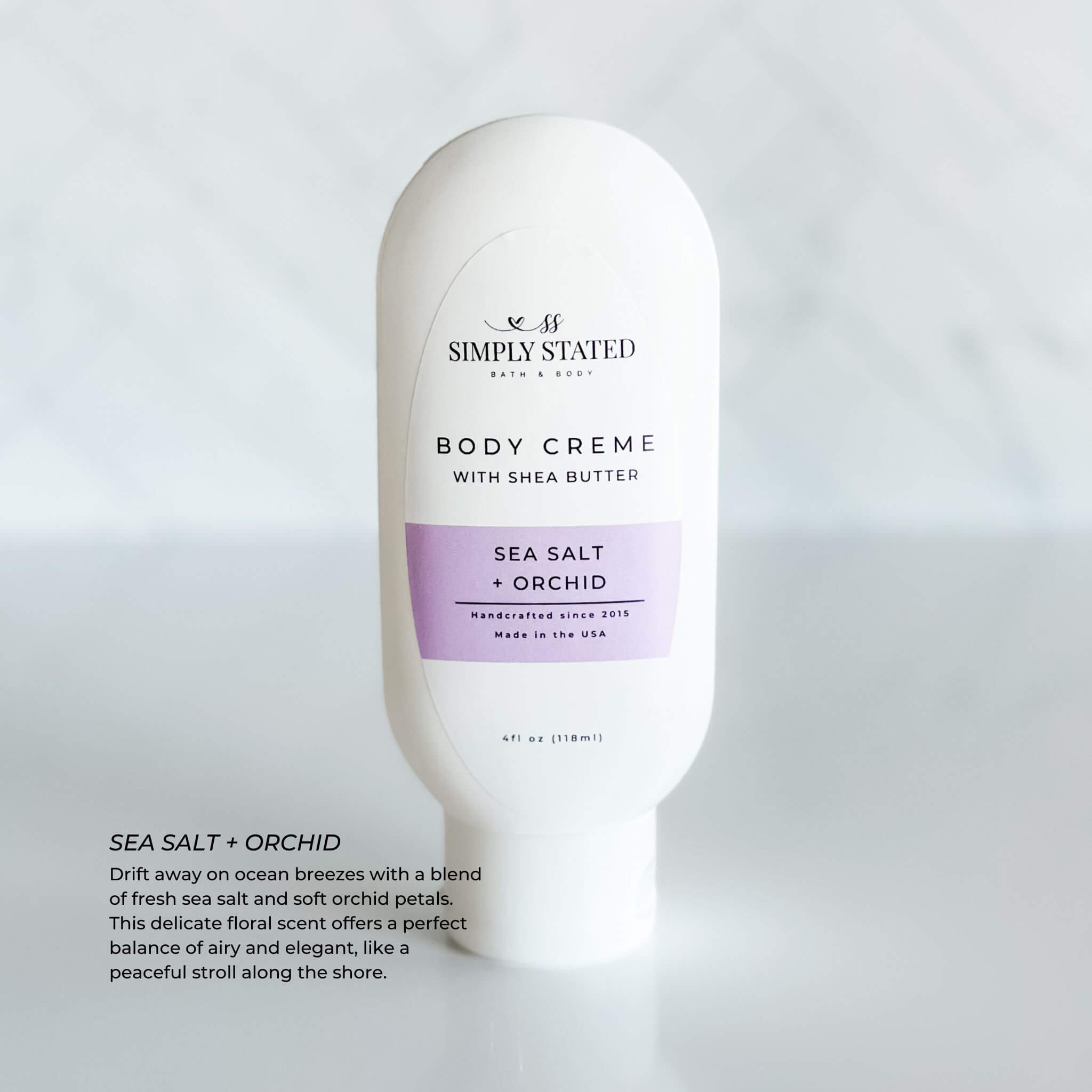 Simply Stated Body Creme in Sea Salt + Orchid scent. A 4oz squeeze bottle with shea butter, offering a delicate floral fragrance of fresh sea salt and orchid petals. Ideal for refreshing, lightweight hydration.