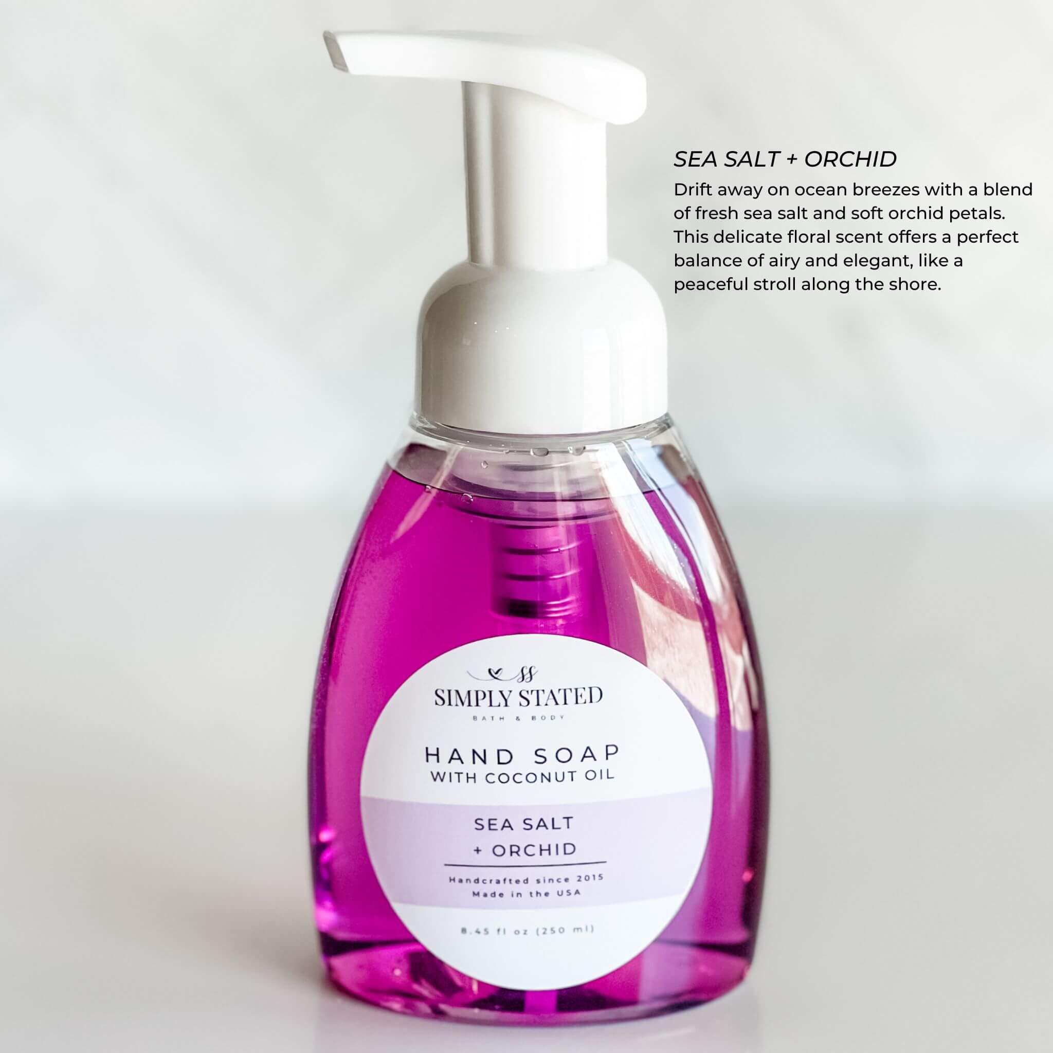 Simply Stated Bath & Body Hand Soap with Sea Salt + Orchid fragrance, in an 8oz bottle. A luxurious blend of coastal sea salt and delicate orchids for a refreshing, elegant touch.