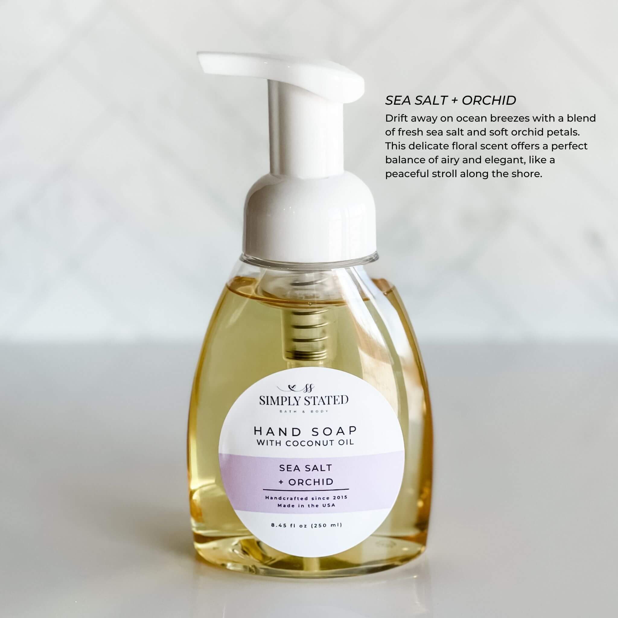 Sea Salt + Orchid Signature Hand Soap from Simply Stated Bath & Body, presented in an 8oz pump bottle. This elegant floral and ocean-inspired scent creates a refreshing cleansing ritual.