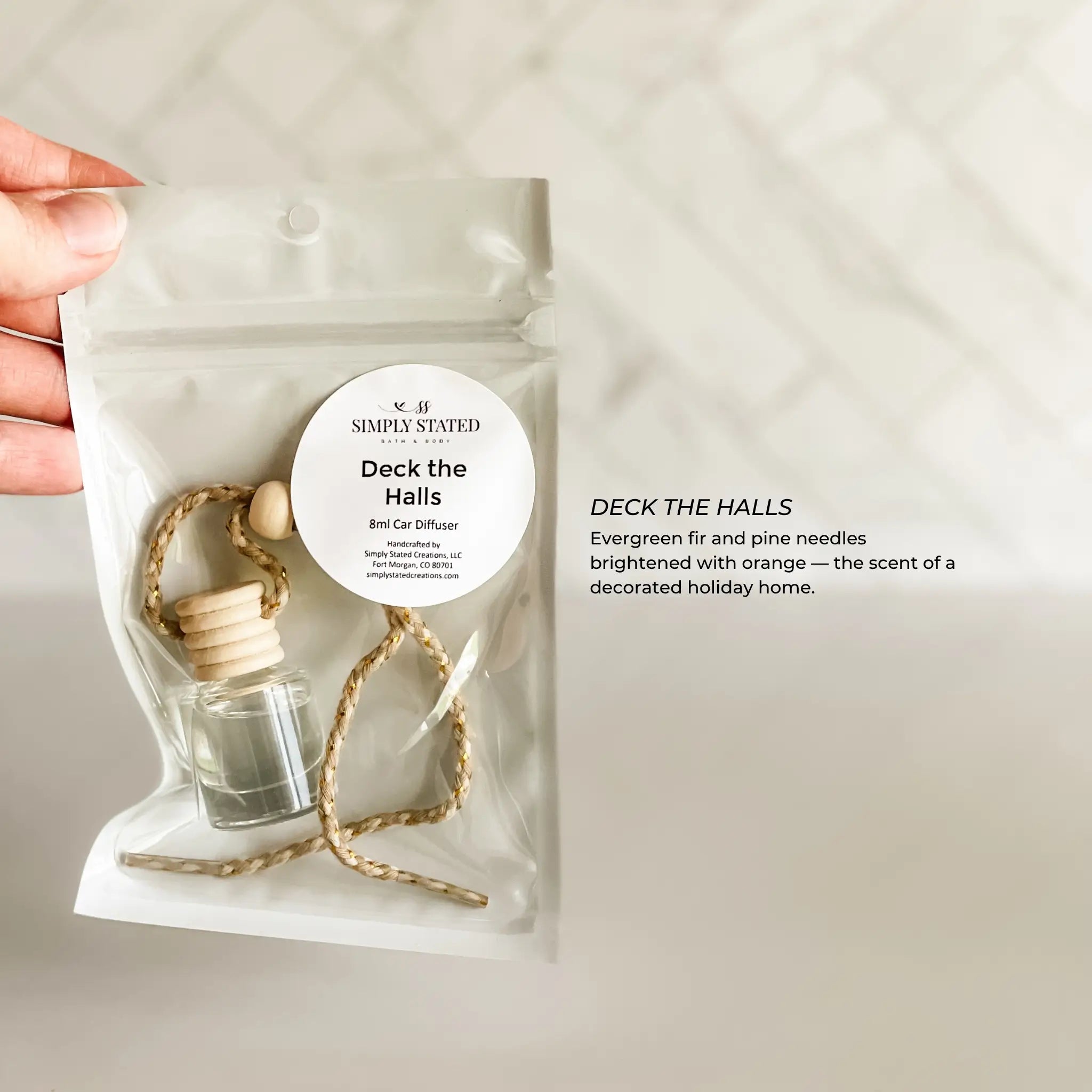 Car diffuser with 'Simply Stated' label on a plain background