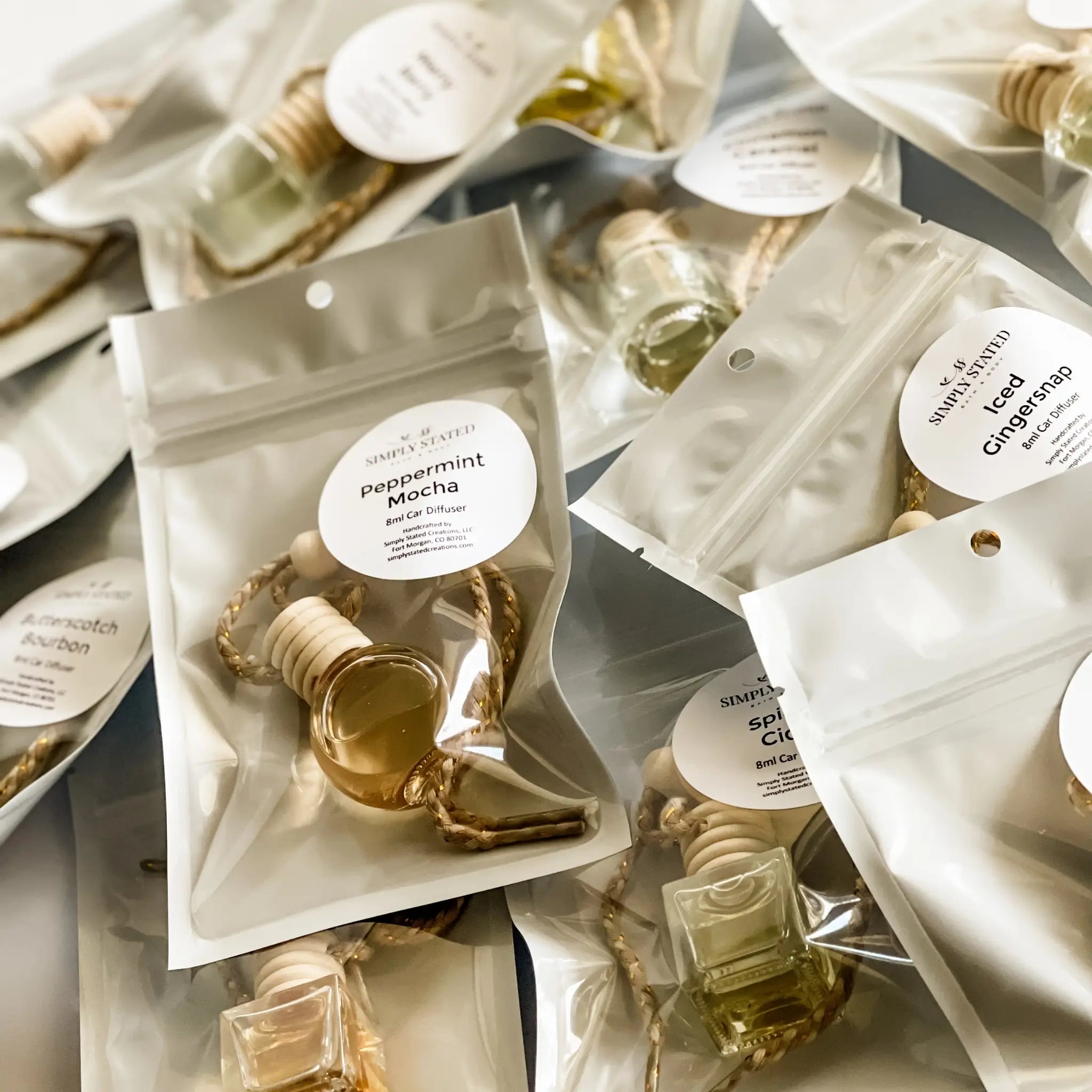 Collection of small fragrance bags with visible labels on a neutral background