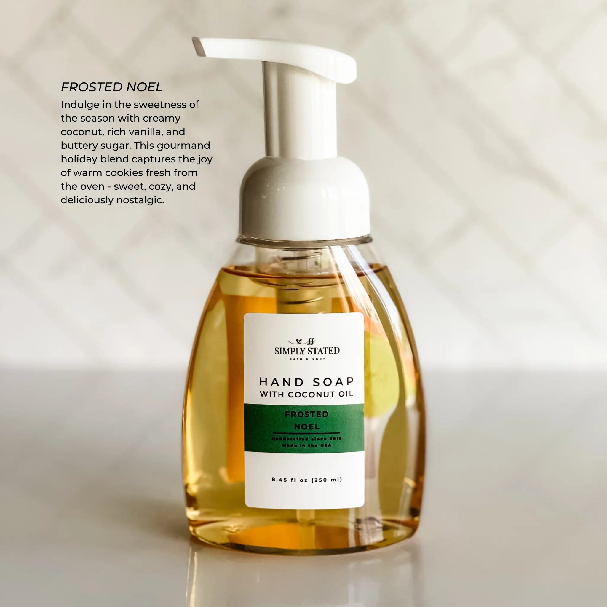 Hand soap bottle labeled 'Frosted Noel' with a white pump on a light background.