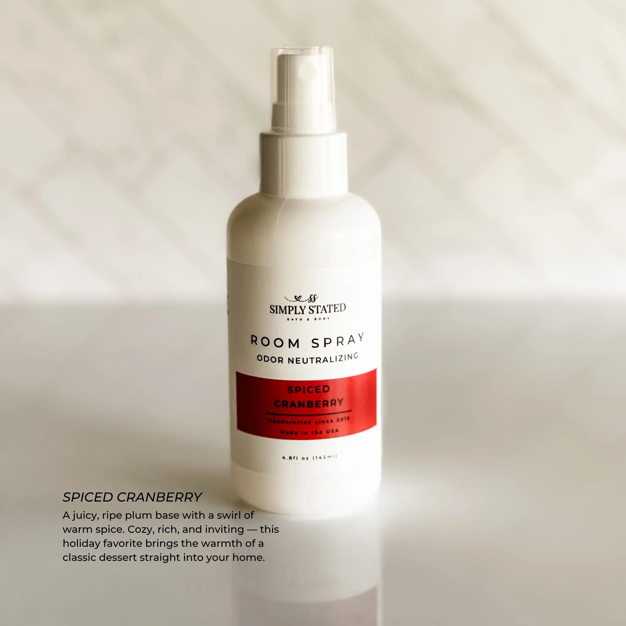 Spiced Cranberry room spray bottle on a neutral background